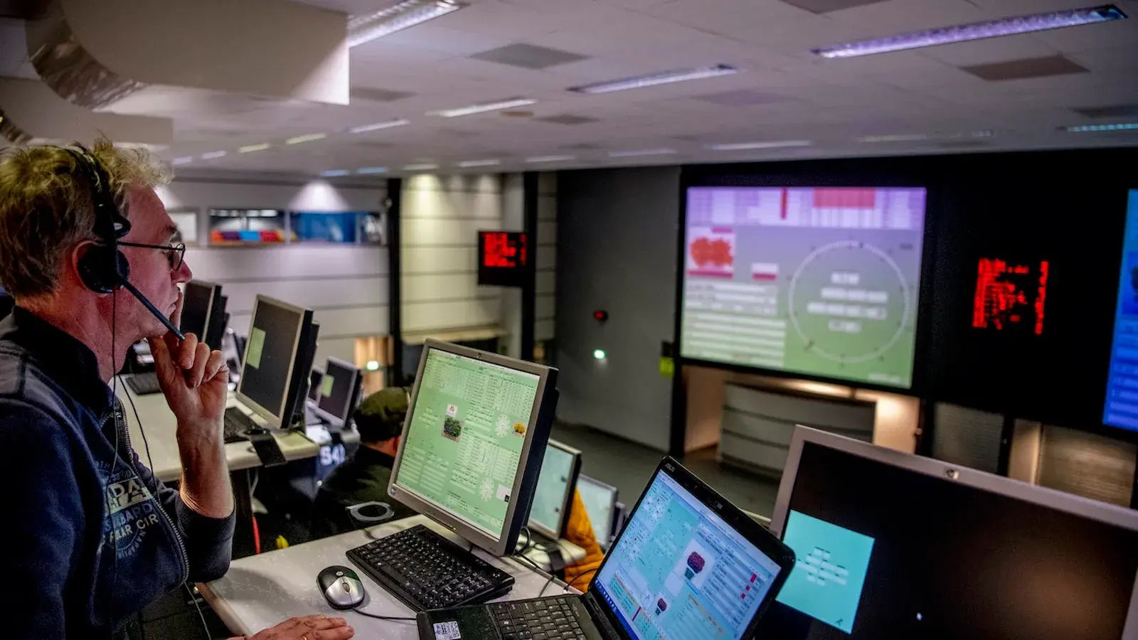 Man with headphone watching his computer screen 