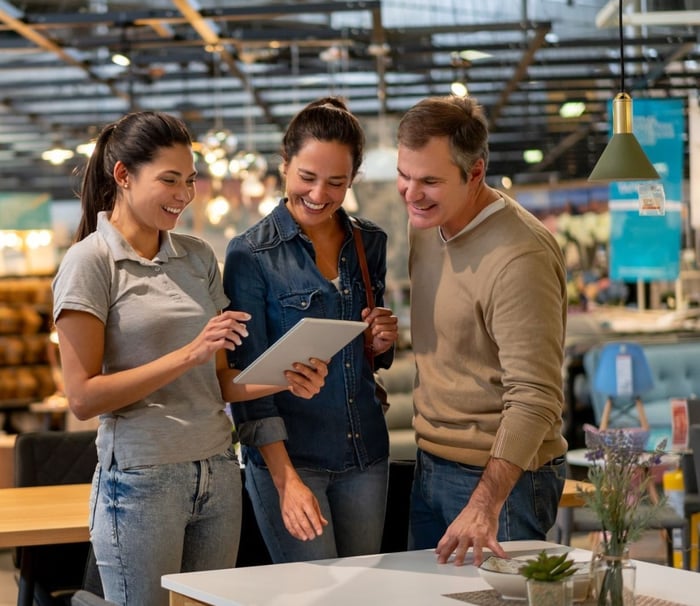 1650887590-mbs-seller-showing-couple-design-on-tablet-retail-gi-1181690920_16-9-1