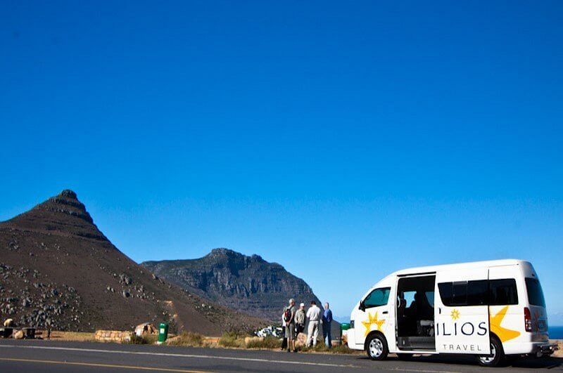 Tourists next to bus near tourist site