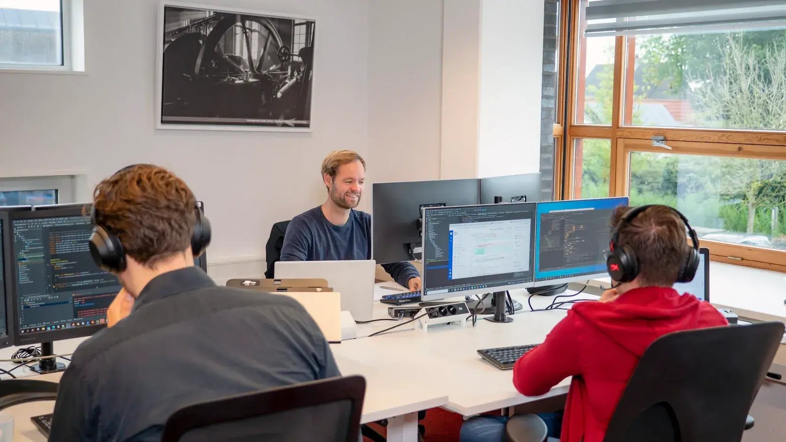 Data engineers working behind their desks.