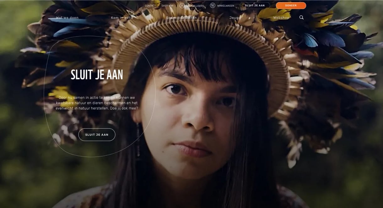 “Close-up of a girl wearing a colorful feather headdress as part of a WWF campaign about nature conservation
