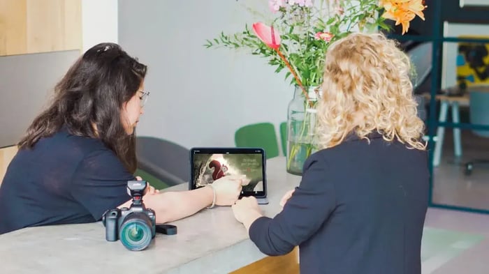 Twee vrouwen kijken naar een tablet.