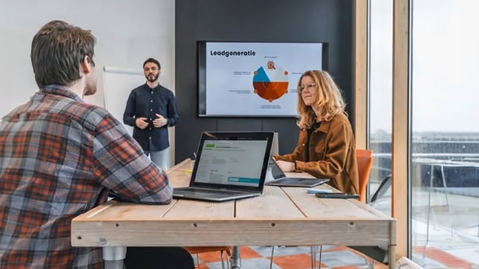 A man presenting a pie chart during a meeting.
