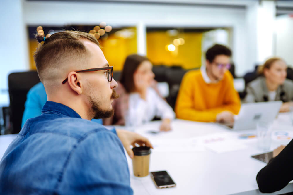 people in office context sitting at a table
