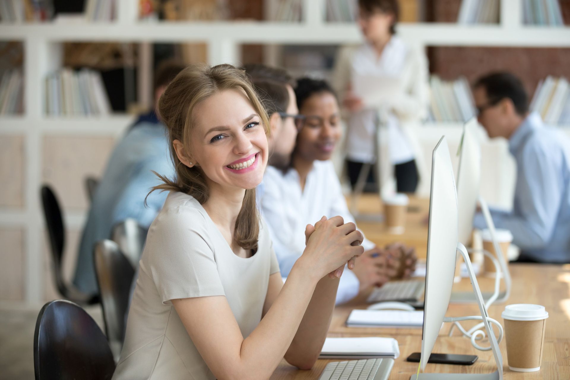 Female employee behind computer.