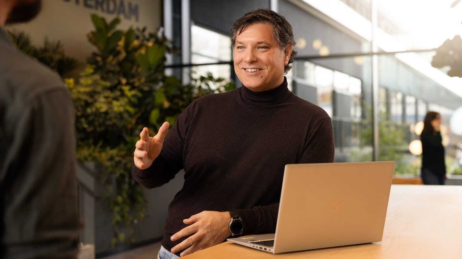 Male colleague holds out his hand.