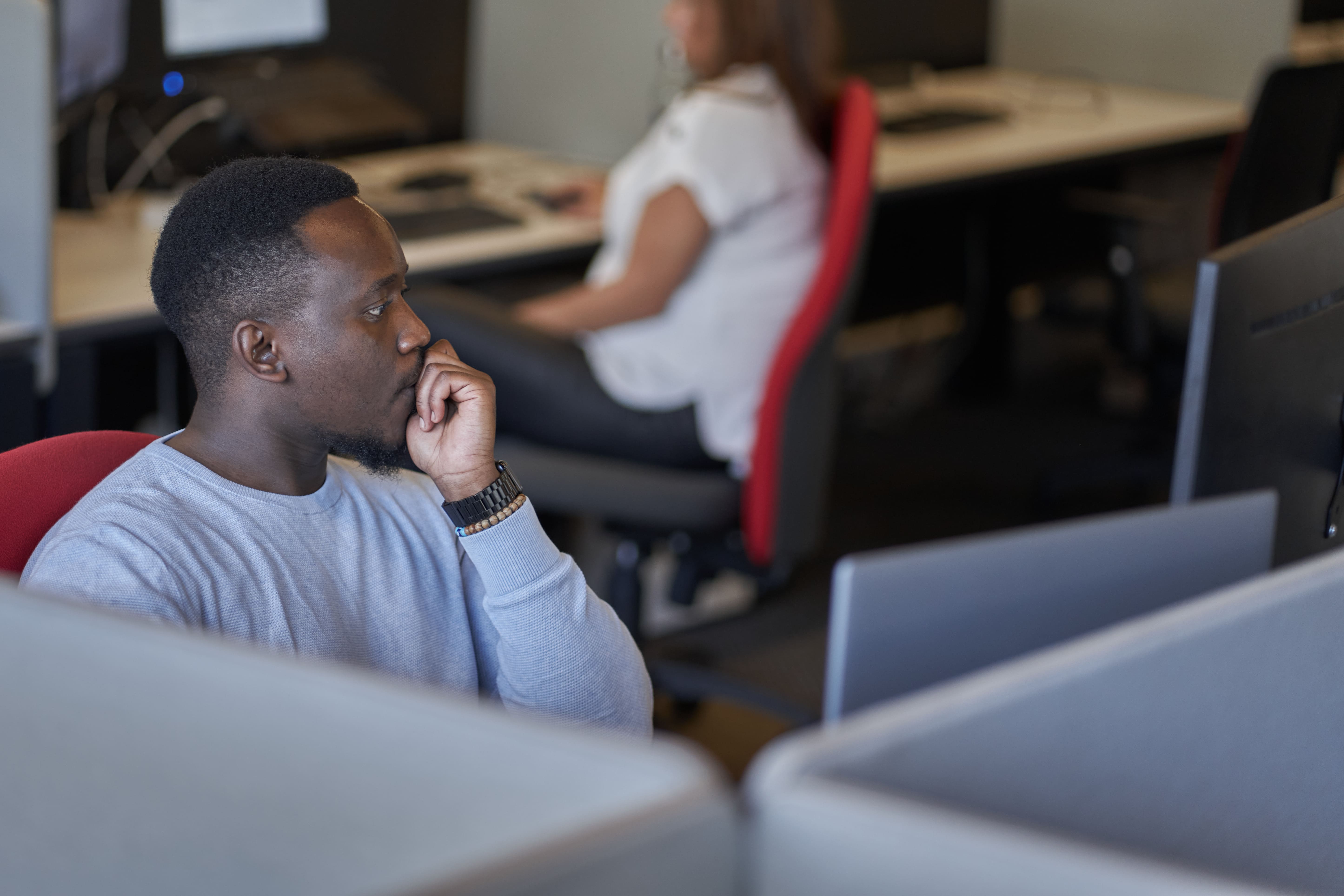 man is looking at his laptop.