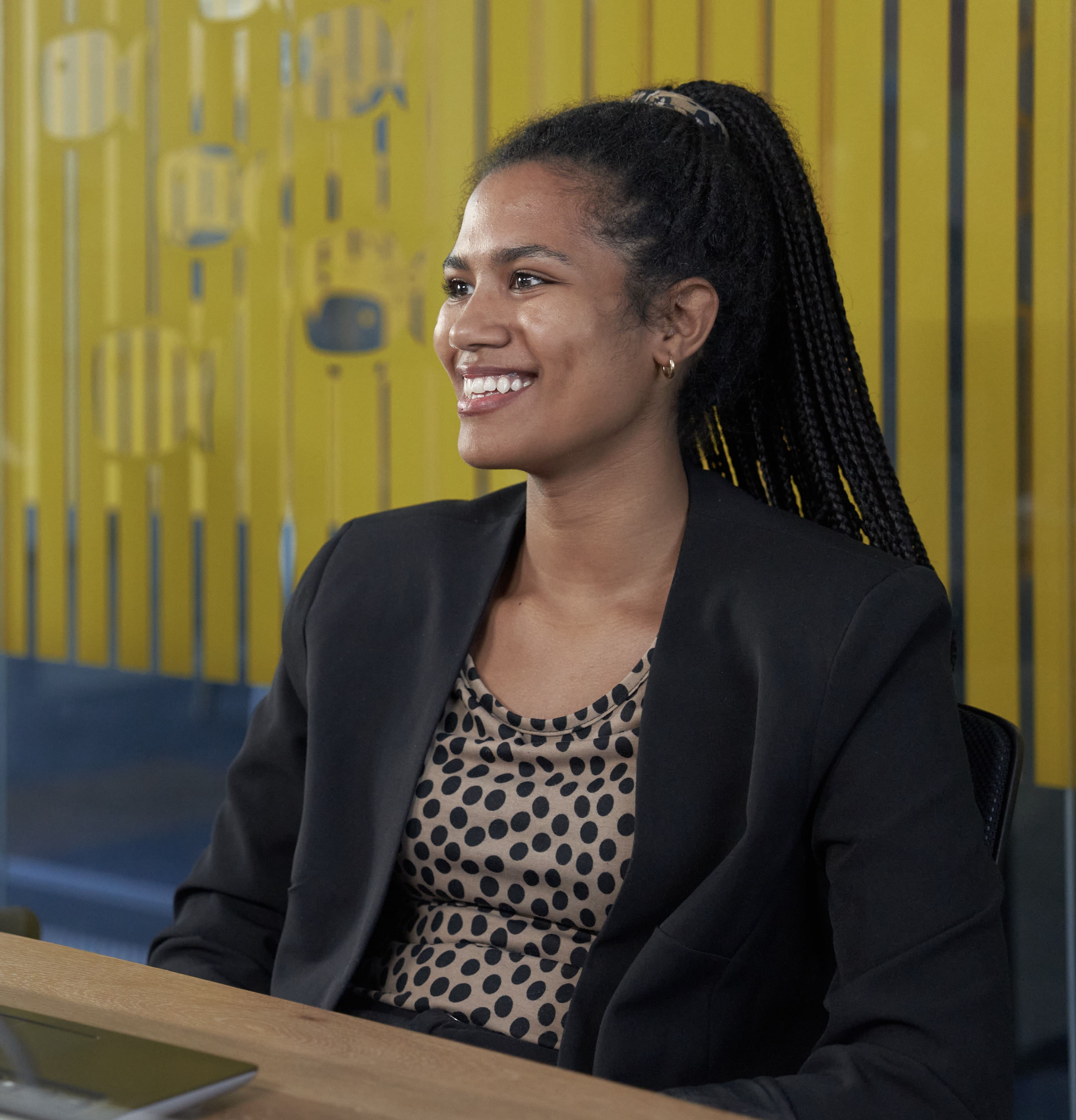 Woman smiles to the side.